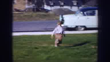 Nebraska (1956): Child Running Under The Grass Parking Cars In The Street And