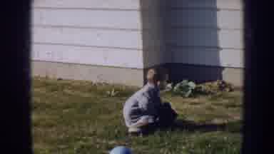 Nebraska (1956): A Little Boy Playing Outside The House In A Sunny Day
