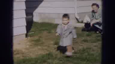 Nebraska (1956): A Child Running Around In A Yard From One Adult To Another