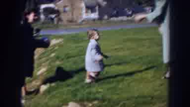 Nebraska (1956): Child And Family On Grass With Child Walking Around And Exploring