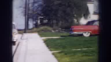 Nebraska (1956): Cars Parked In Front Of Sidewalk Driveway With Red Car In Front