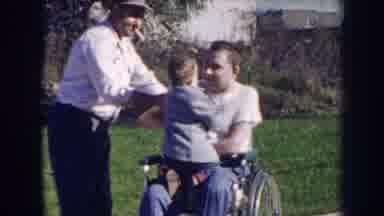 Nebraska (1956): Kid Kissing A Man On The Wheelchair Along With An Elderly Person