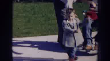Nebraska (1956): Man Wearing White Shirt Picks Up Toddler Wear Grey Coat On A