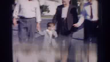 Nebraska (1956): A Small Child Walking Hand In Hand With Three Adult Men