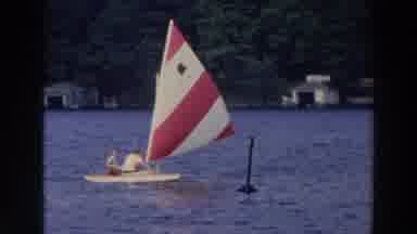 Wisconsin (1966): Man And Boy Sail Sunfish Sailboat On The Water Waterfront Homes