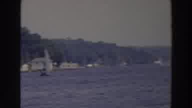 Wisconsin (1966): Men Holding Child In Arms And Watching Boats Sailing In Cove