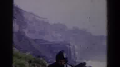 Niagra Falls Canada (1963): Person Wearing Black Raincoat Stands In Front Of