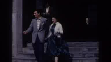 Niagra Falls Canada (1963): Couple Walks Out Of Grey Stone Building On A Bright