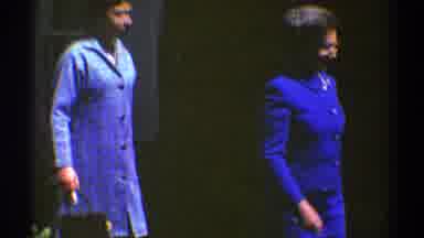 Clarendon Hills Illinois (1969): Two Women Wearing Blue Dresses Walk Past White