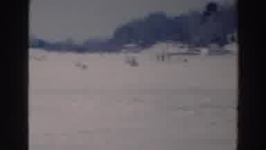 Tustin Wisconsin (1964): Person Wearing Black Coat Walks Across Frozen Lake On A
