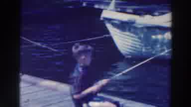 Tustin Wisconsin (1964): Small Young Child Fishing By Boats Catches Small Fish On