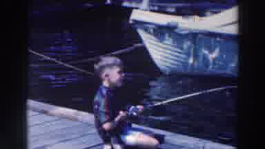 Tustin Wisconsin (1964): Young Boy Fishing Off The Dock With Fishing Rod And Lure