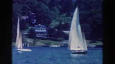 Tustin Wisconsin (1964): A Set Of White Sailboats Sailing On A Calm Day In A Blue