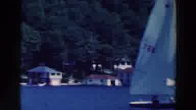 Tustin Wisconsin (1964): A White Yacht Is Lying In The Lake With Blue Water
