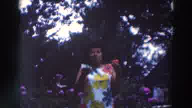 Tustin Wisconsin (1964): Woman In White Flower Dress Holding A Cucumber And Tomato