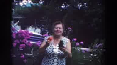 Tustin Wisconsin (1964): Woman Wearing Blue And White Dress Holds Red And Green