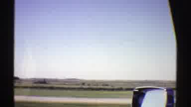 Nebraska (1969): Flat Land Mountains And Other Lane With Cars Seen From Moving Car