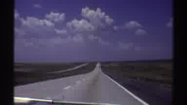 Nebraska (1969): View Of Grey Asphalt Highway White Clouds And Blue Sky On A Sunny