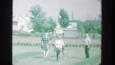 Michigan (1964): Five People Pick Up Objects From Field On A Sunny Day