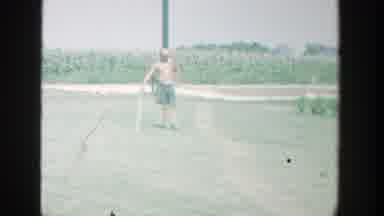 Michigan (1964): A Man Stands In A Field Leaning On A Club As A Small Animal