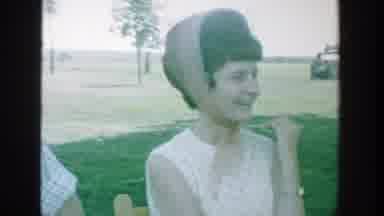 Michigan (1964): A Group Of People Talking And Laughing In A Circle On A Park