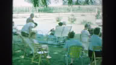 Michigan (1964): Man Wearing Blue And Grey Shorts Walks With Watermelon Slice On A