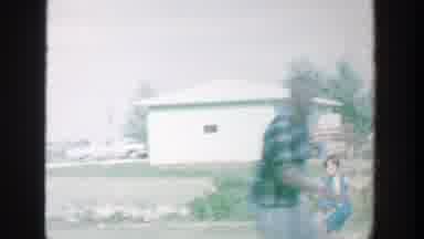 Michigan (1964): Children Play Games On Grassy Front Yard At Daytime Near Busy