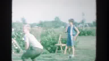 Michigan (1964): A Family Playing Baseball In A Garden Together On A Nice Day