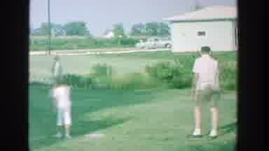 Michigan (1964): People Playing An Impromptu Softball Game On A Clear Day