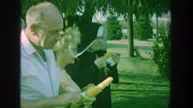 Michigan (1964): Nun And Other People Eating Corn On The Cob Outdoors In A Field