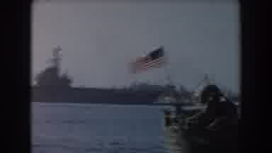 California (1961): Two Military Ships In Harbor With Top Part Of Man Wearing