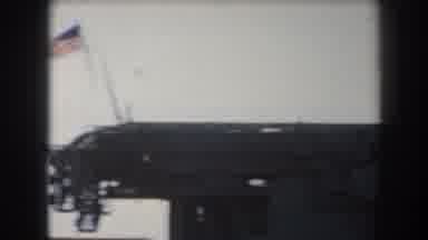 California (1961): View Of Grey Battleship And American Flag On A Sunny Day