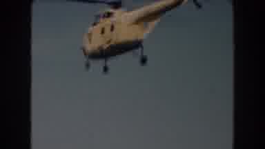 California (1961): Helicopter Flying In The Skies And Person Sailing On The River