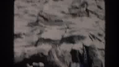 California (1961): Waterfall Cascades Down Icy Mountain By A Stone Footbridge And