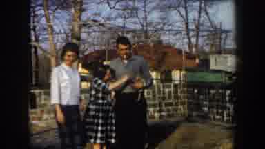 California (1961): Husband Wife And Daughter Giving Pose To The Photo Playing With