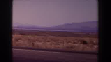 Texas (1958): White Truck Follows Grey Car On Highway On A Sunny Day