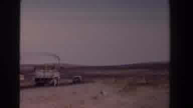 Texas (1958): White Truck Follows Grey Car While Red Big Rig Truck travels On