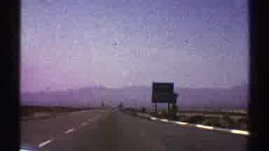 Nevada (1969): Driving Down A Long Straight Road With A Mountain Far In The