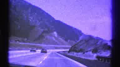 Nevada (1969): A Vehicle Drives Through A Mountain Pass On A Major Highway