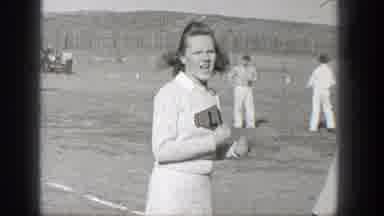 Washington (1938): A Cheerleader Girl Dressed In White Cheering For A Group Of