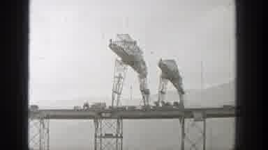 Washington (1938): Metal Bridge With Hillside In The Background And Metal Cross