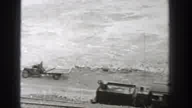 Washington (1938): Freighter Train Unloading Passing By A River With Abandoned Car