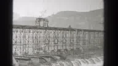 Washington (1938): Two Trucks Driving Across A Bridge High In The Air
