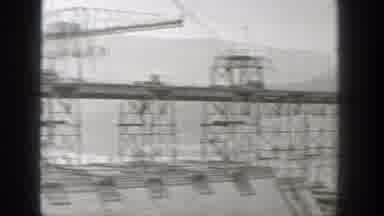 Washington (1938): Metal Towers Topped With Cranes Run Across A Dam With Flood