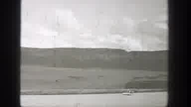 Washington (1938): A Man Rides A Watercraft Down A River And Passes A Stationary