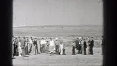 Washington (1938): A Flying Drone Passed By A Group Of People In The Desert