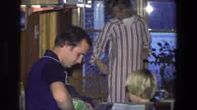 Saint Paul Minnesota (1971): Man Wearing Blue Shirt Opens Green Box While Boy