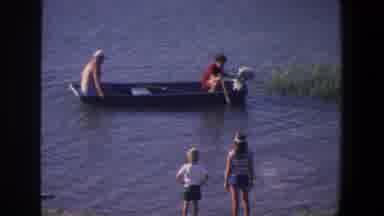 Saint Paul Minnesota (1971): Woman And Child Watching Men Inside A Boat Fishing On