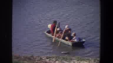 Saint Paul Minnesota (1971): Two Adults And Two Children Push A Small Boat Off The