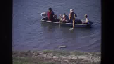 Saint Paul Minnesota (1971): A Group Of People Rowing A Boat Near The Shore With